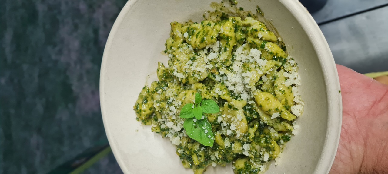 Handmade pasta shells with fresh basil pesto