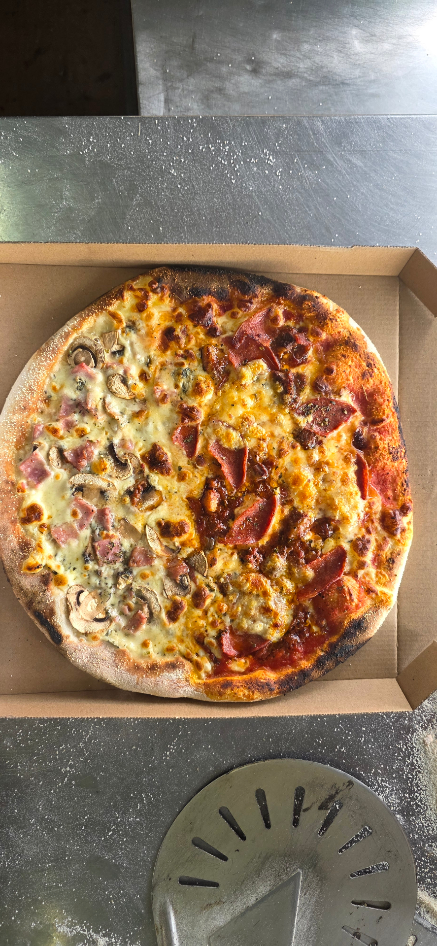 Half-and-half Neapolitan pizza with salami and mushrooms